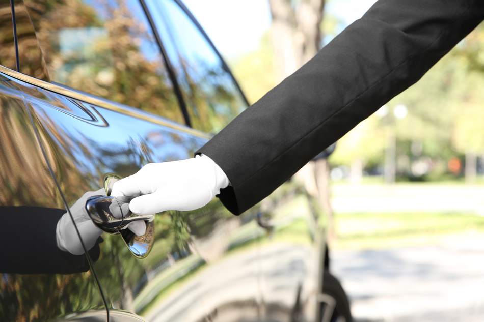 A chauffeur opening the car door